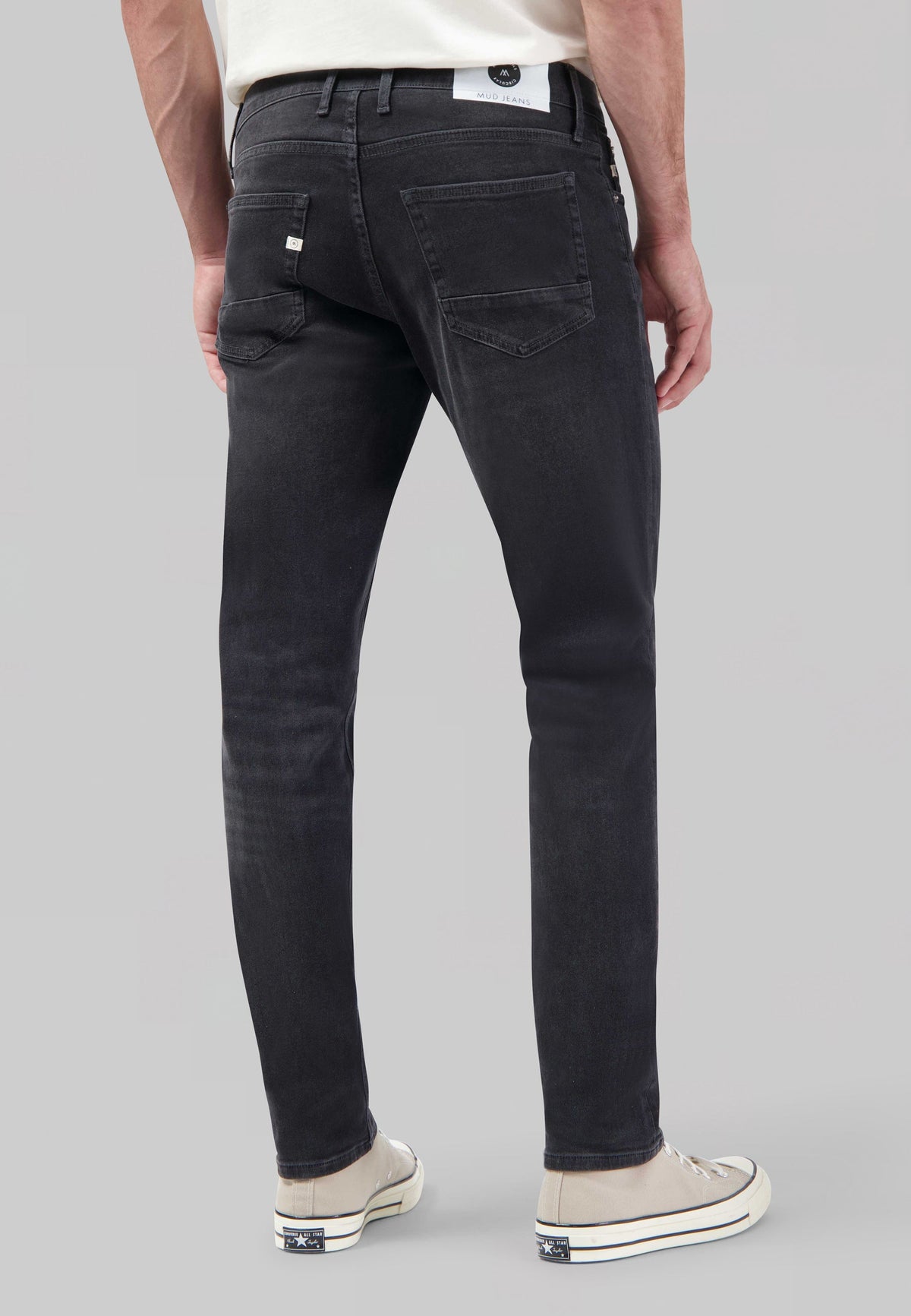 Sustainable MUD Jeans, ethical dark blue denim, straight leg fit, paired with a plain white t-shirt.