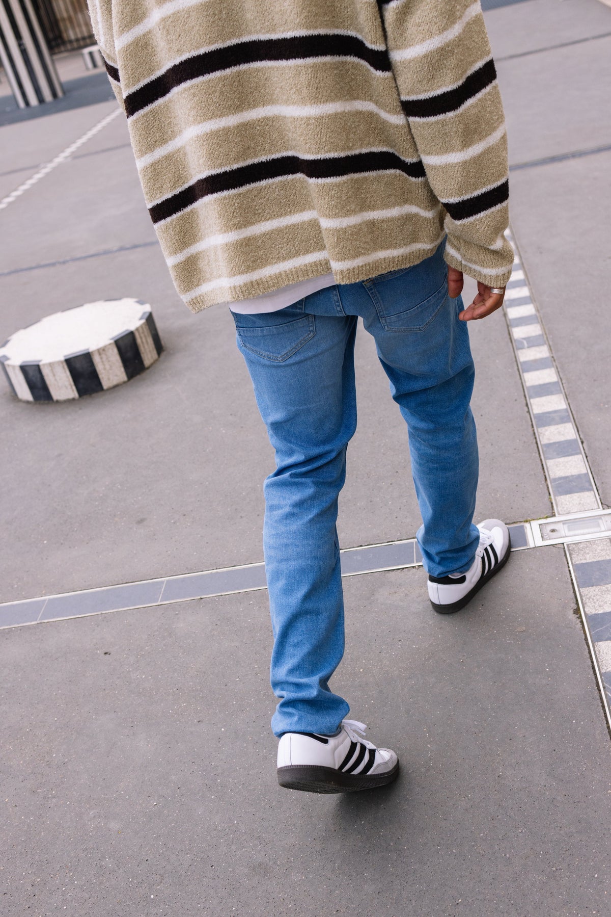 Sustainable MUD Jeans in a dark-gray wash, crafted from organic cotton, showcasing a relaxed fit and ethical design.