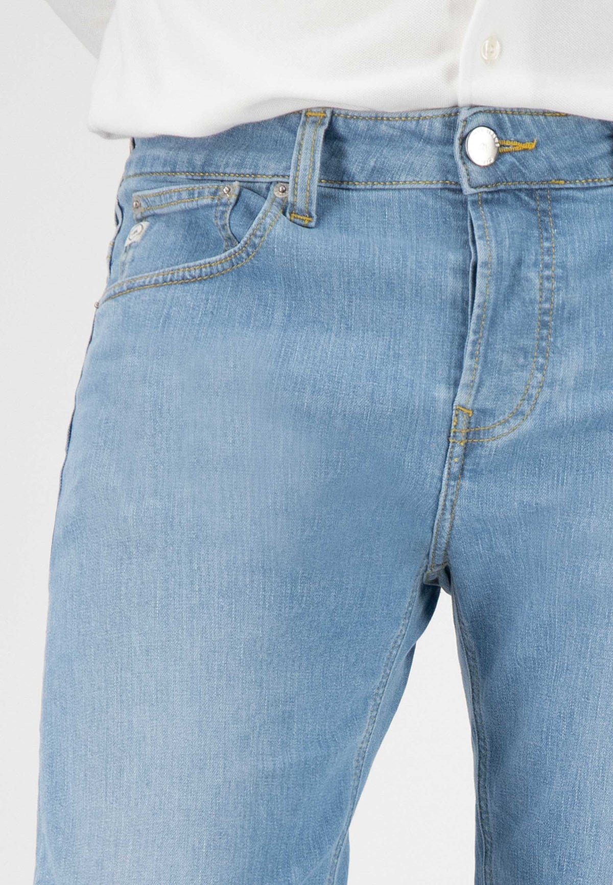 Sustainable MUD Jeans in dark blue denim with cargo pockets, paired with a black tank top for an ethical style statement.