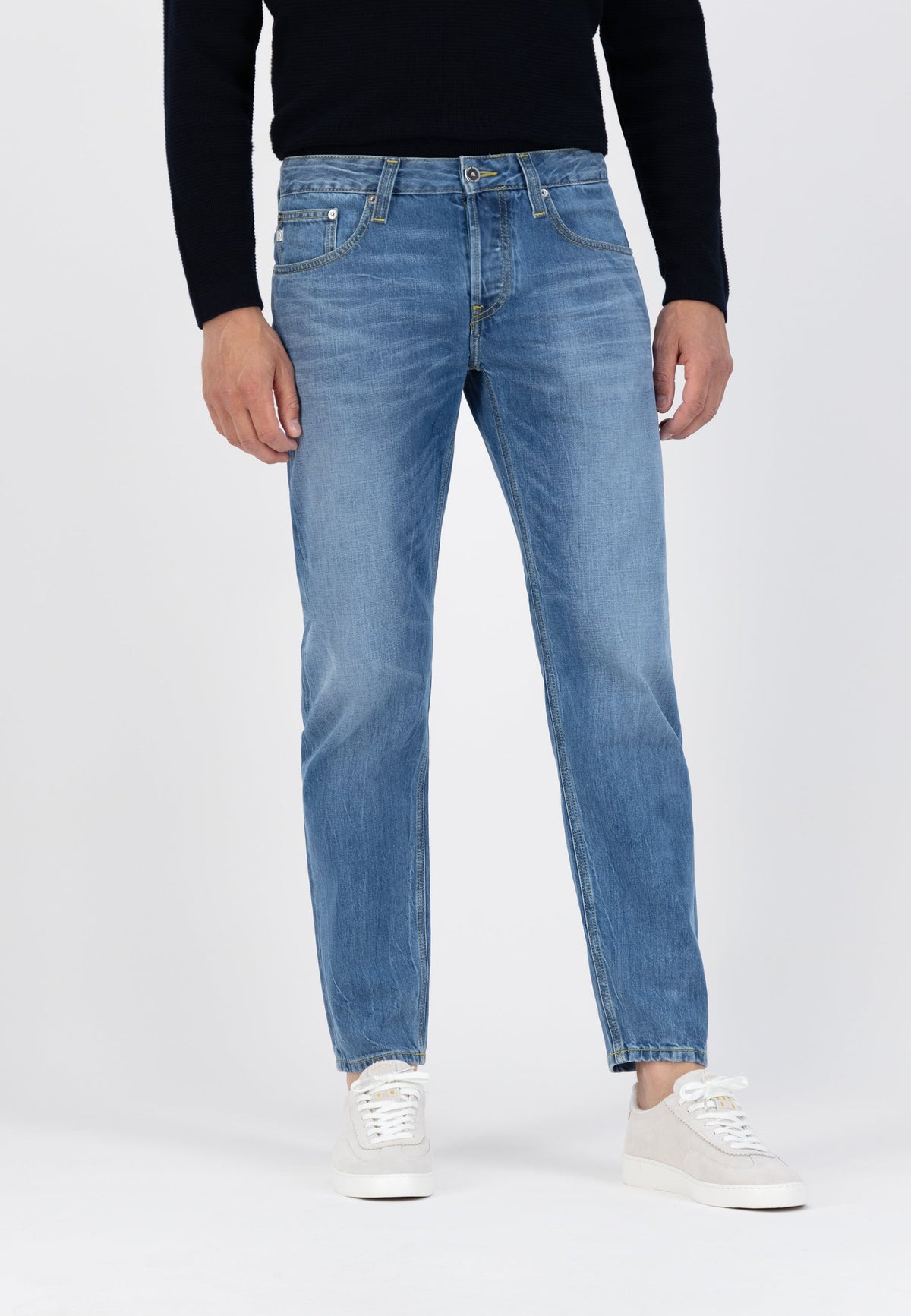 Sustainable MUD Jeans denim shirt in light blue, made from organic cotton, paired with black pants for an ethical style.