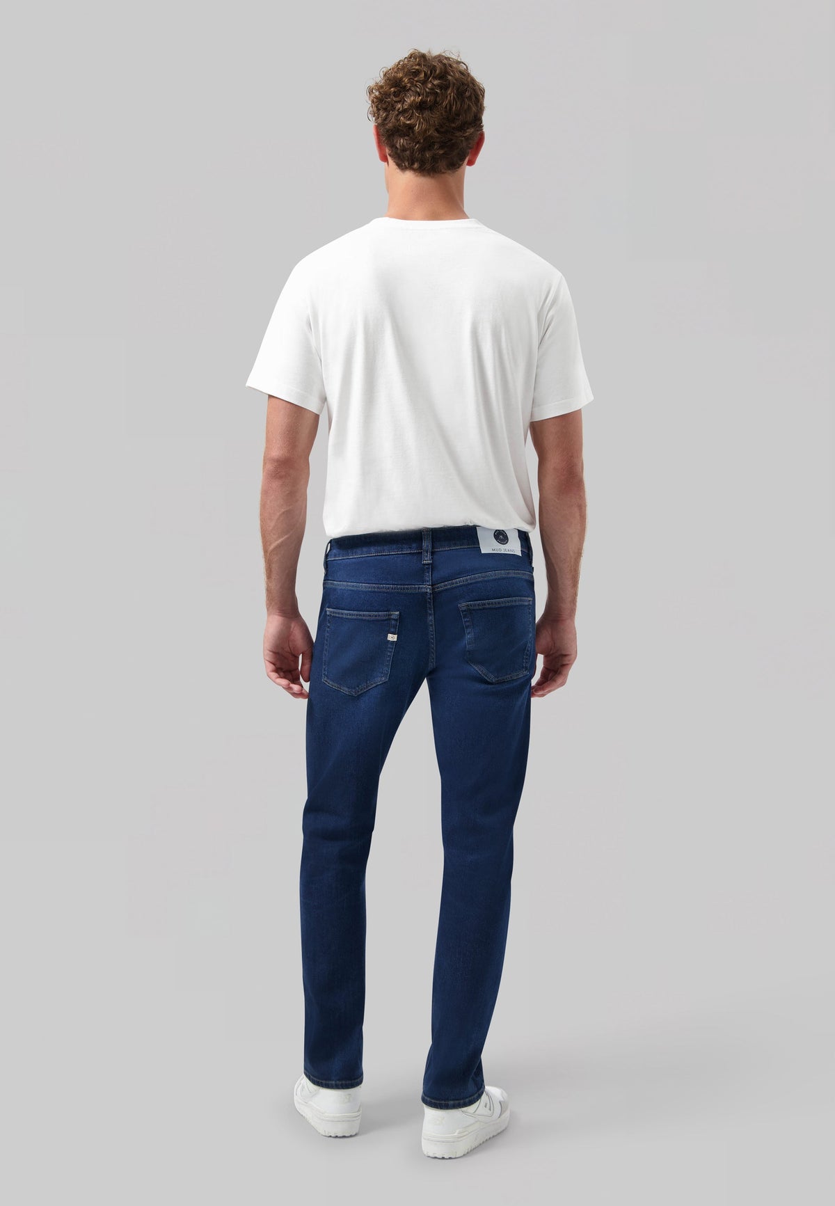 Sustainable MUD Jeans denim vest paired with a blue cap, highlighting eco-friendly fashion in deep indigo tones.