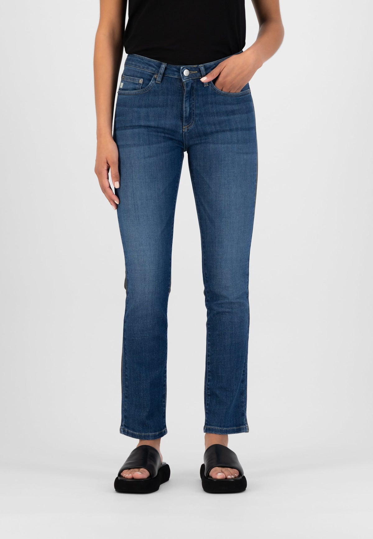 Dark blue straight-leg denim jeans styled with a black T-shirt and black sandals, showcasing casual chic fashion.