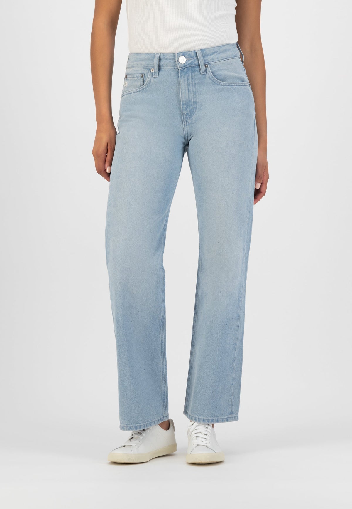 Light blue high-waisted wide-leg jeans paired with a white sleeveless top and white sneakers on a person.
