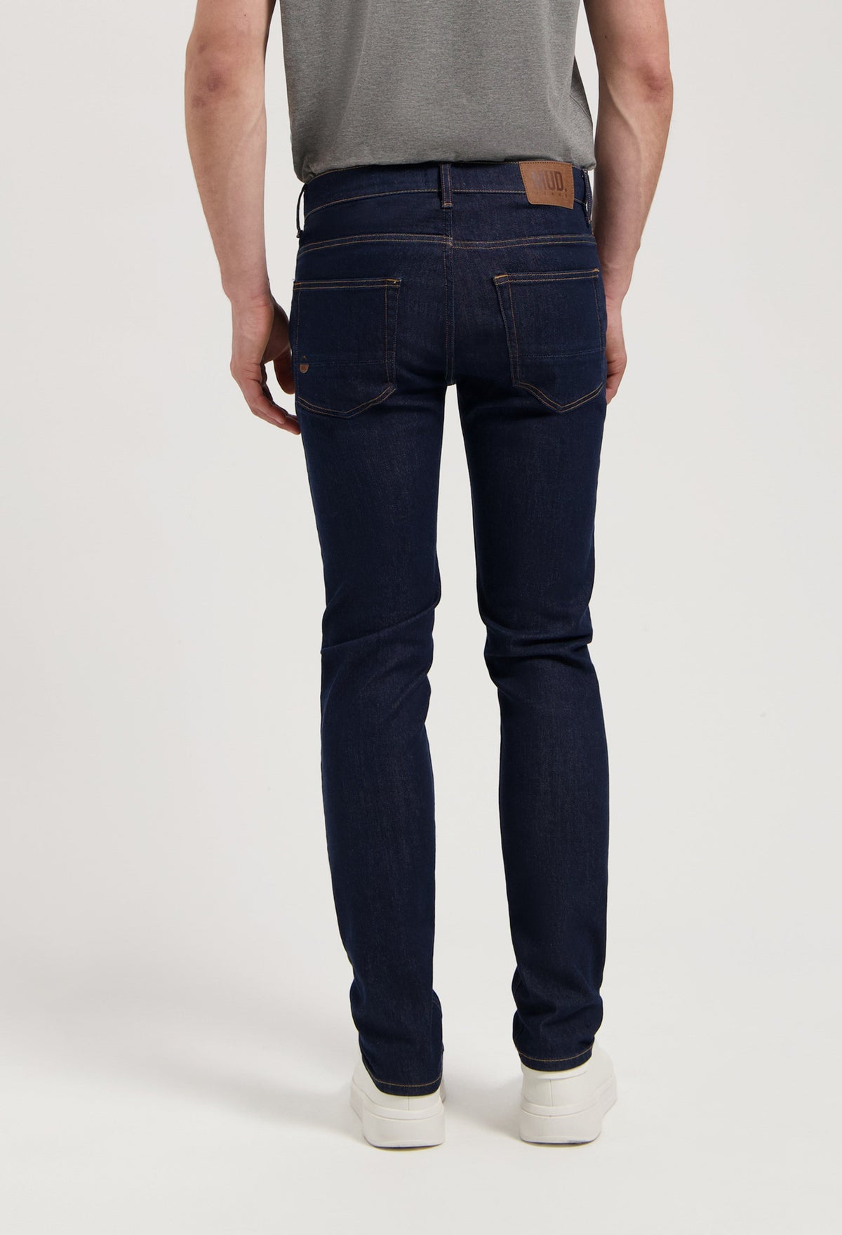 Sustainable MUD Jeans denim shorts in dark blue, paired with a simple white t-shirt, embodying ethical fashion.