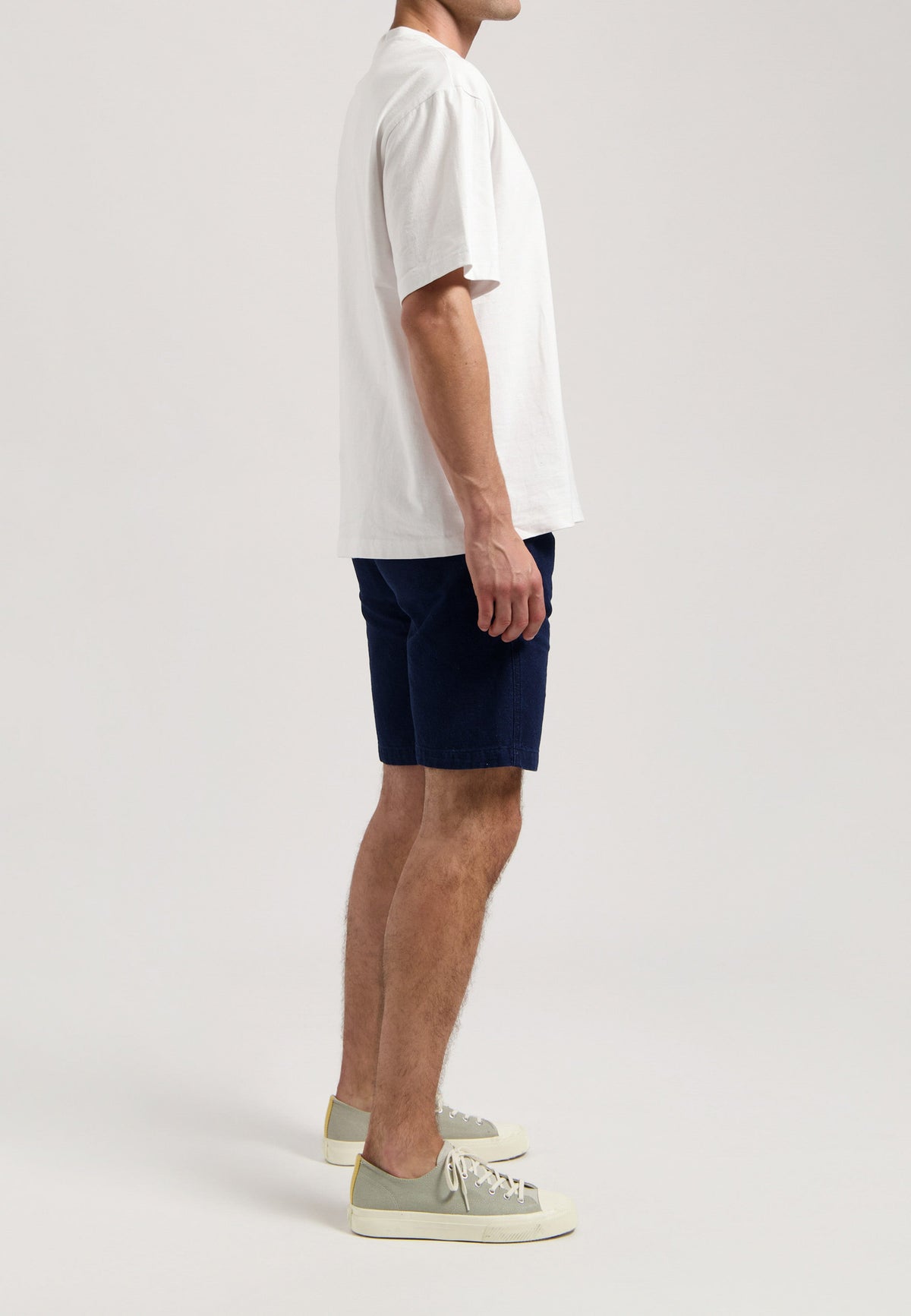 Sustainable MUD Jeans in light blue denim, featuring eco-friendly materials and a classic fit, paired with white sneakers.