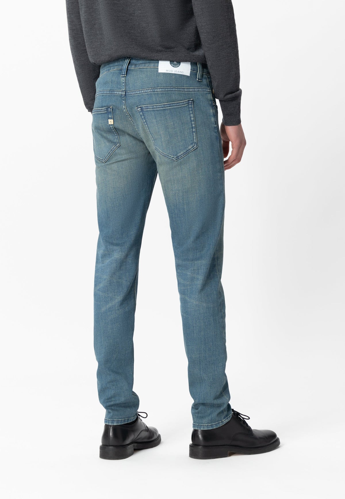Sustainable MUD Jeans in rich blue denim, featuring a classic cut, promoting ethical fashion and eco-friendly style.