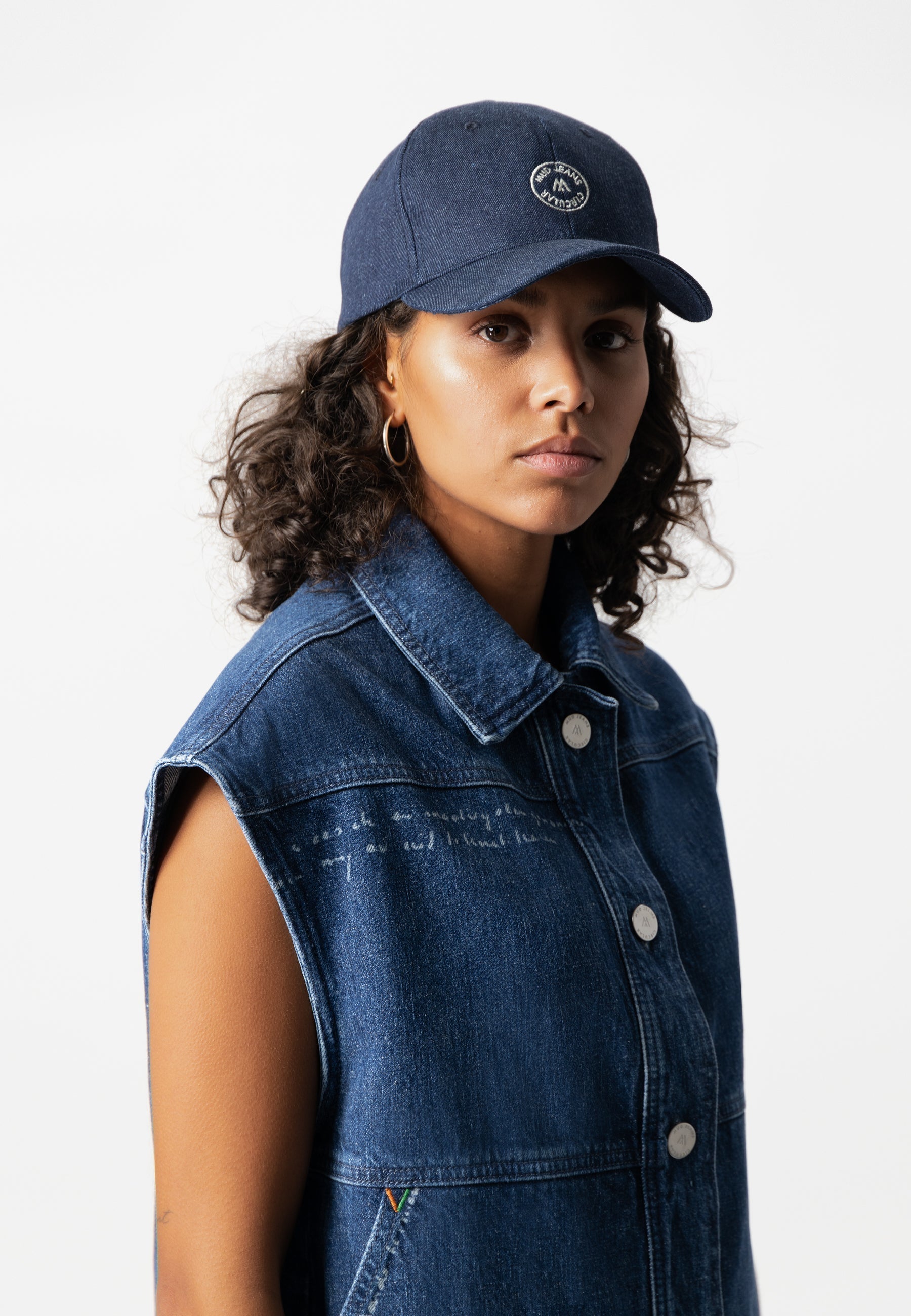 Sustainable Mud Jeans denim jacket in dark blue, featuring ethical design with button-down front and chest pockets.