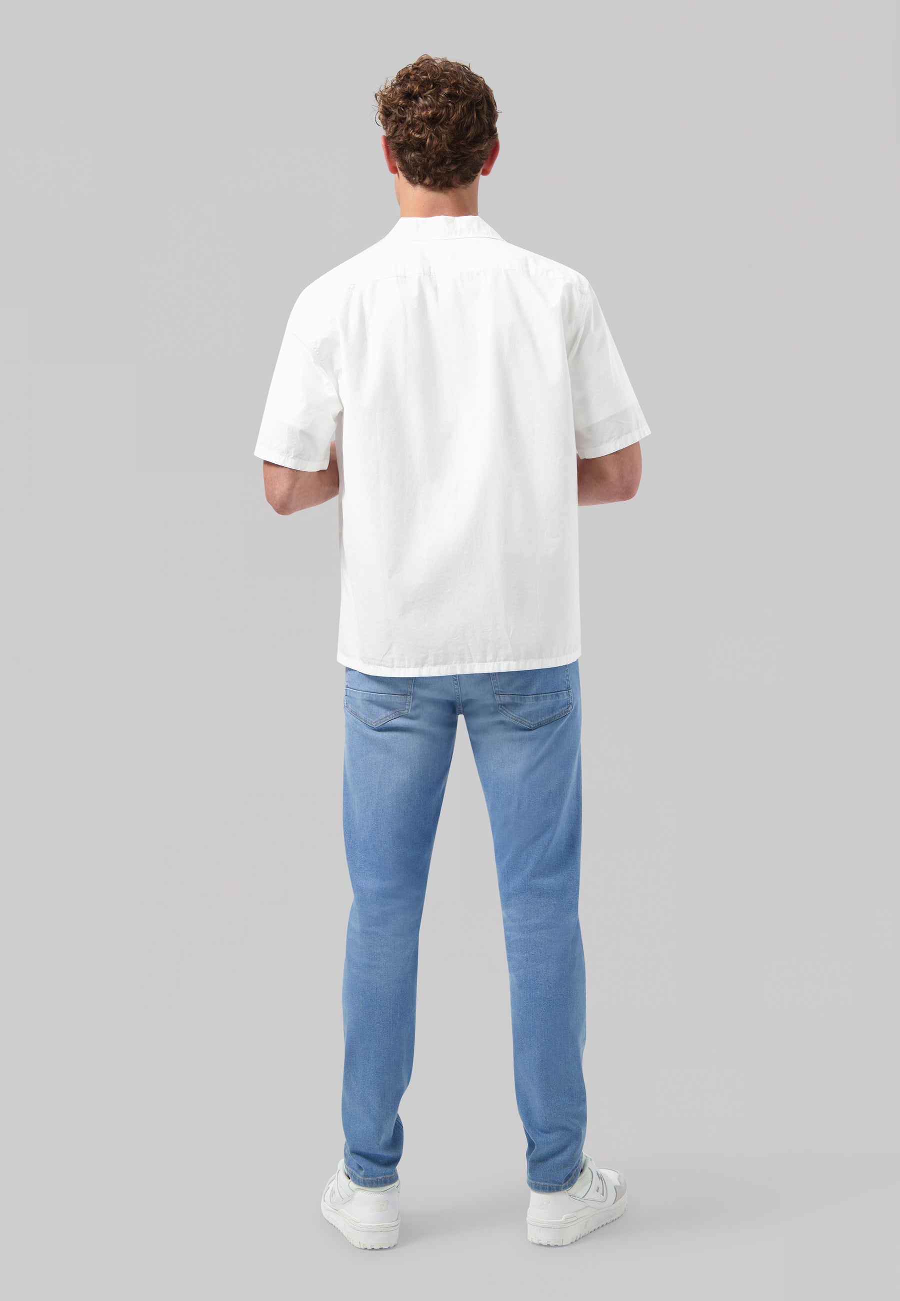 Sustainable MUD Jeans dark denim shirt made from organic cotton, featuring a button-up front and chest pocket.