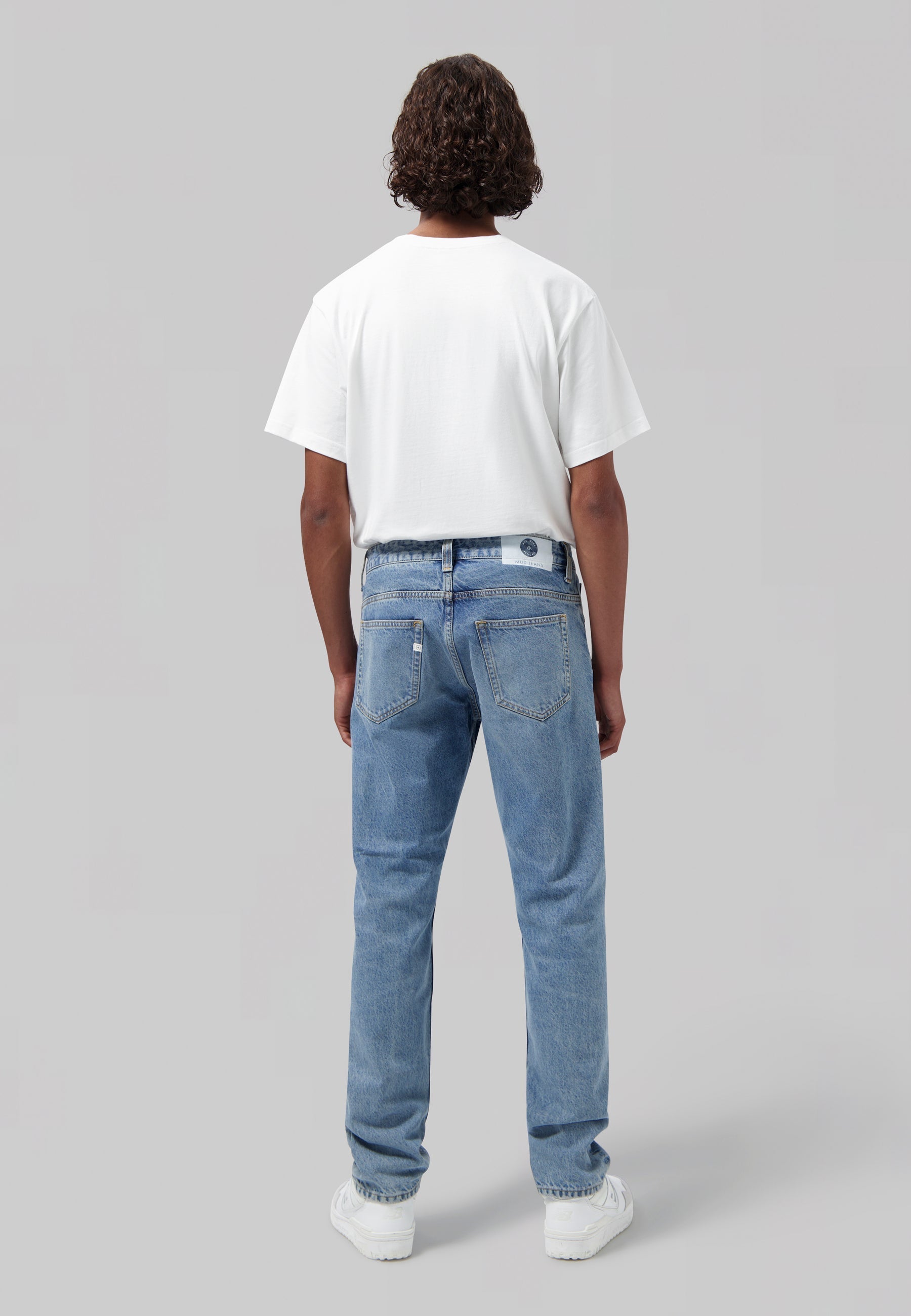 Sustainable MUD Jeans in light blue denim, crafted from organic cotton, showcasing a classic five-pocket design.