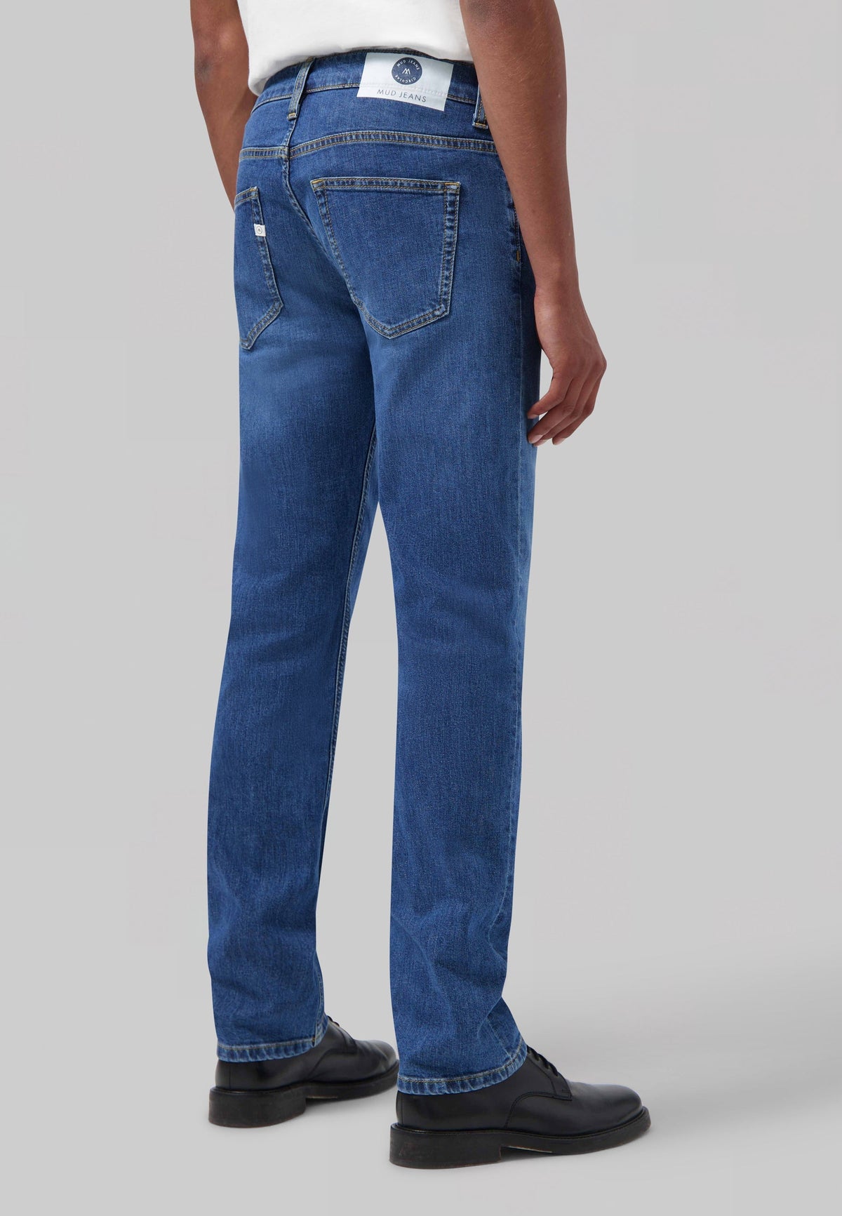 Sustainable MUD Jeans in deep blue denim, crafted from organic cotton, showcasing a classic fit with ethical fashion focus.