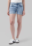 Light blue denim shorts with five-pocket design and casual fit, paired with white and black sneakers, perfect for summer.