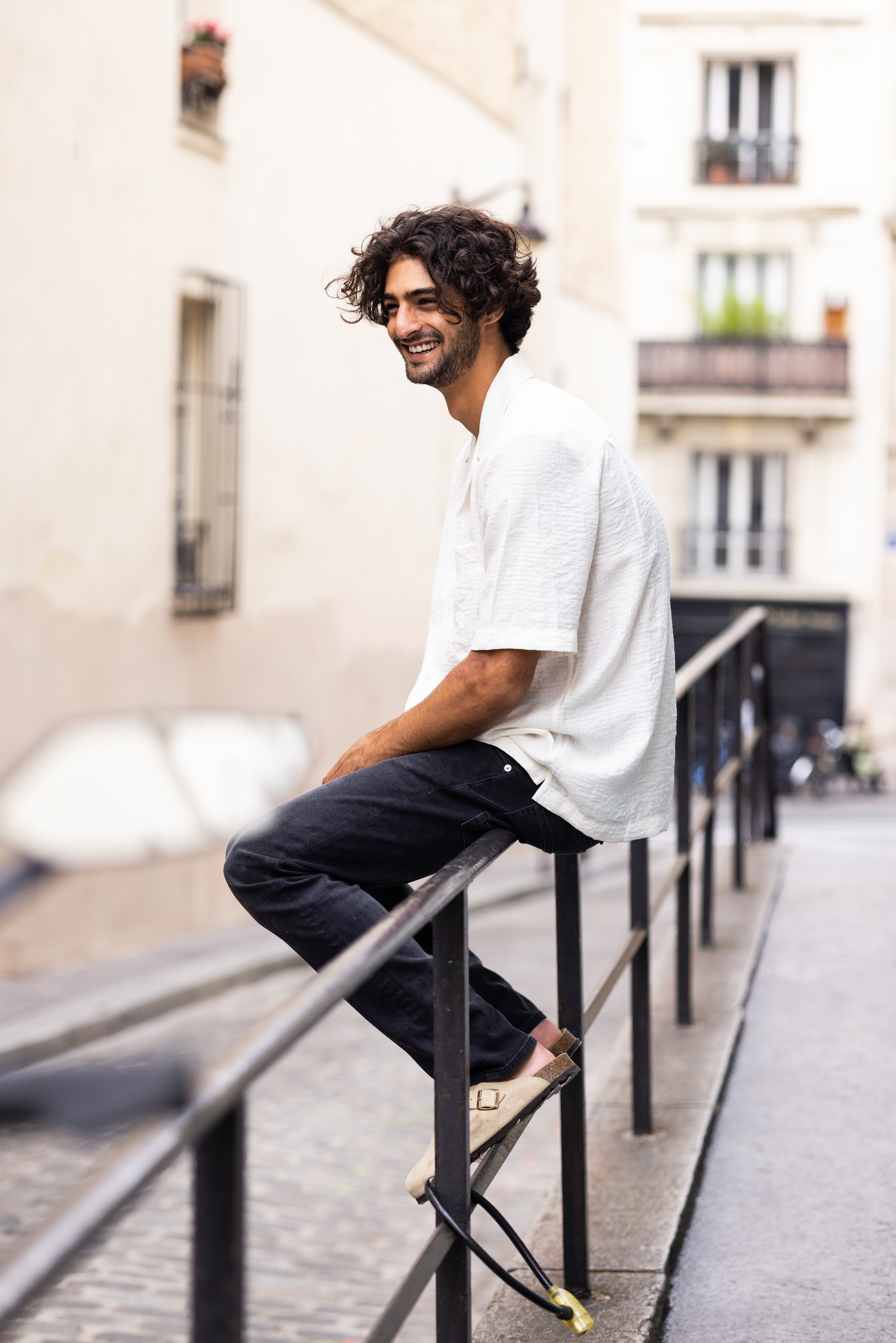 Sustainable MUD Jeans in dark denim, ethically crafted, paired with a black t-shirt, showcasing eco-friendly fashion.