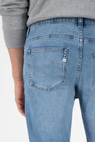 Sustainable MUD Jeans in deep blue denim, showcasing ethical fashion with a straight-leg cut and comfortable high waist.