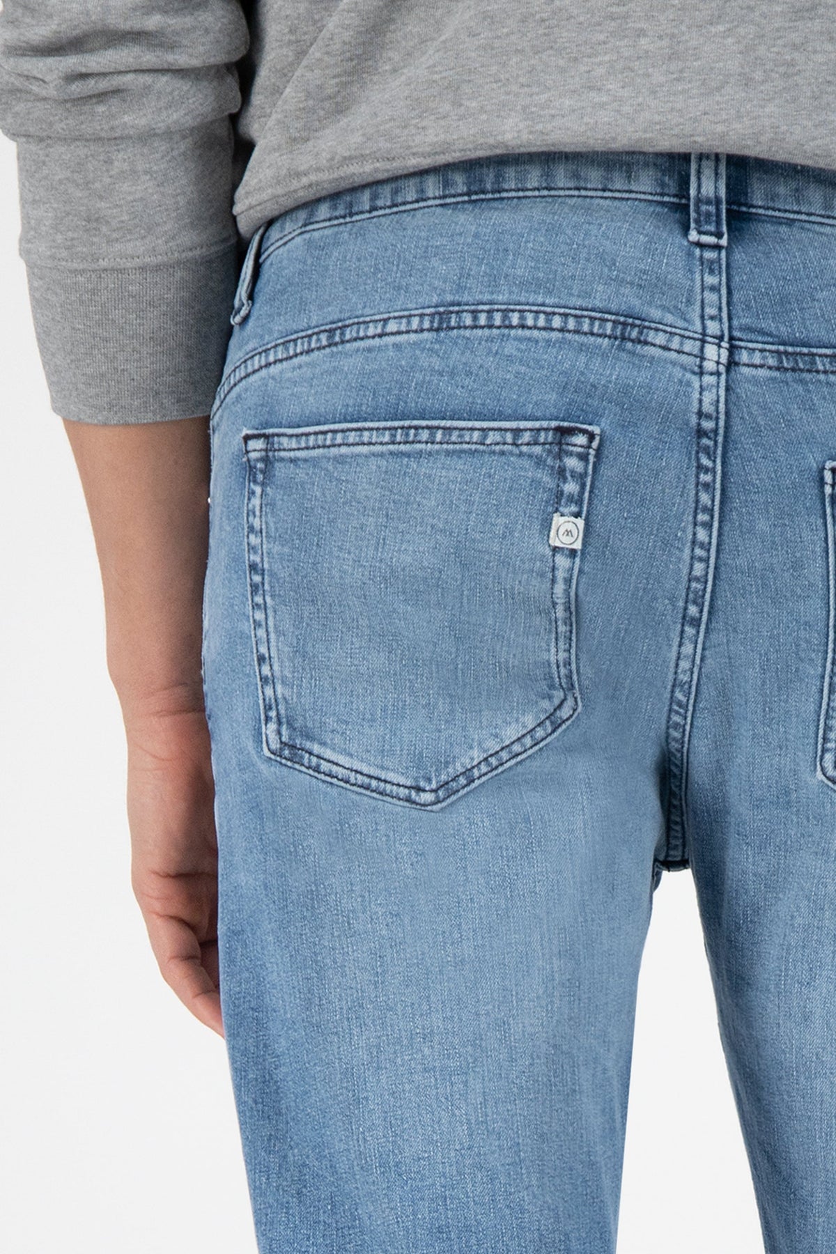 Sustainable MUD Jeans in deep blue denim, showcasing ethical fashion with a straight-leg cut and comfortable high waist.