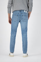 Sustainable MUD Jeans in dark blue denim, paired with a black T-shirt, promoting ethical fashion style.