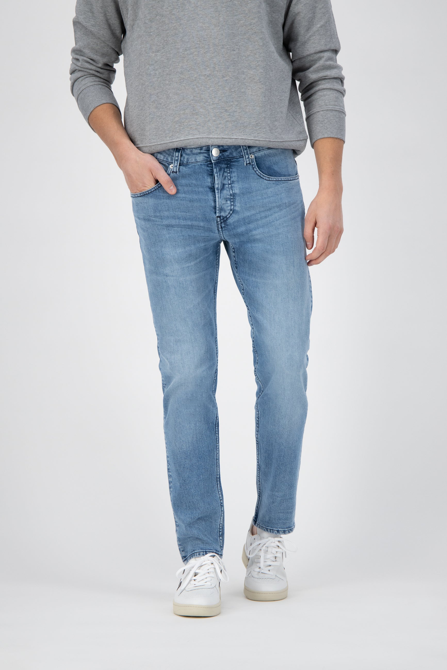Sustainable MUD Jeans in deep blue denim, showcasing ethical fashion with a straight-leg cut and comfortable high waist.