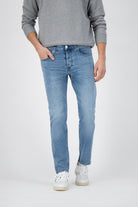 Sustainable MUD Jeans in deep blue denim, showcasing ethical fashion with a straight-leg cut and comfortable high waist.