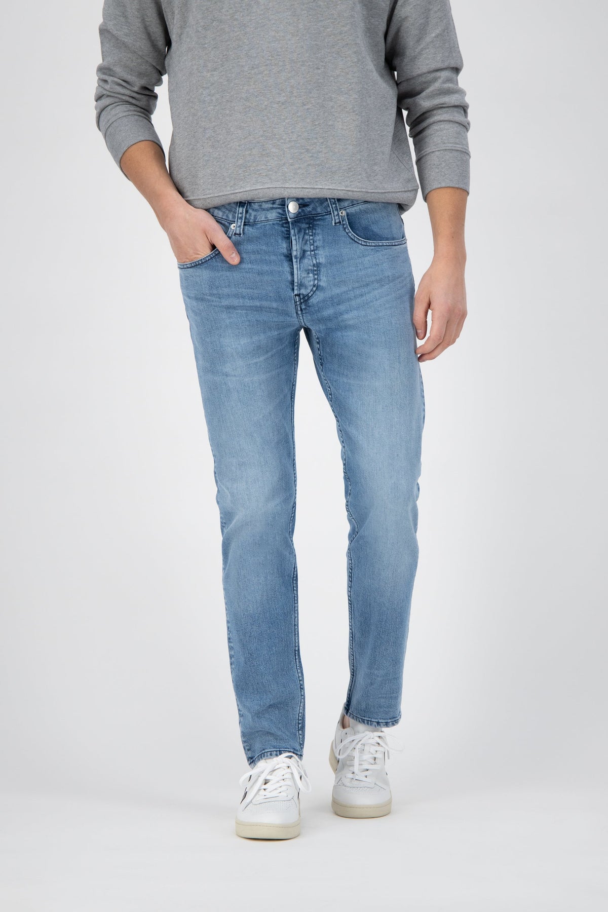 Sustainable MUD Jeans in deep blue denim, showcasing ethical fashion with a straight-leg cut and comfortable high waist.
