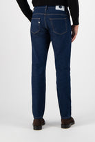 Sustainable MUD Jeans in light blue denim paired with a white tee and navy tote, emphasizing ethical fashion choices.