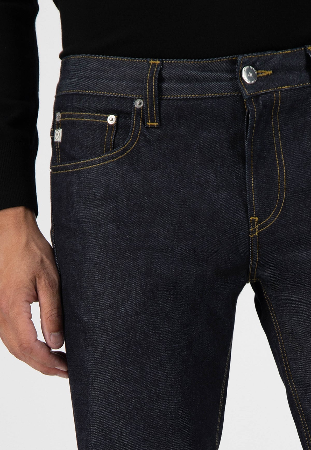 Sustainable MUD Jeans in dark blue denim, crafted with ethical materials, featuring classic back pockets and stitching.