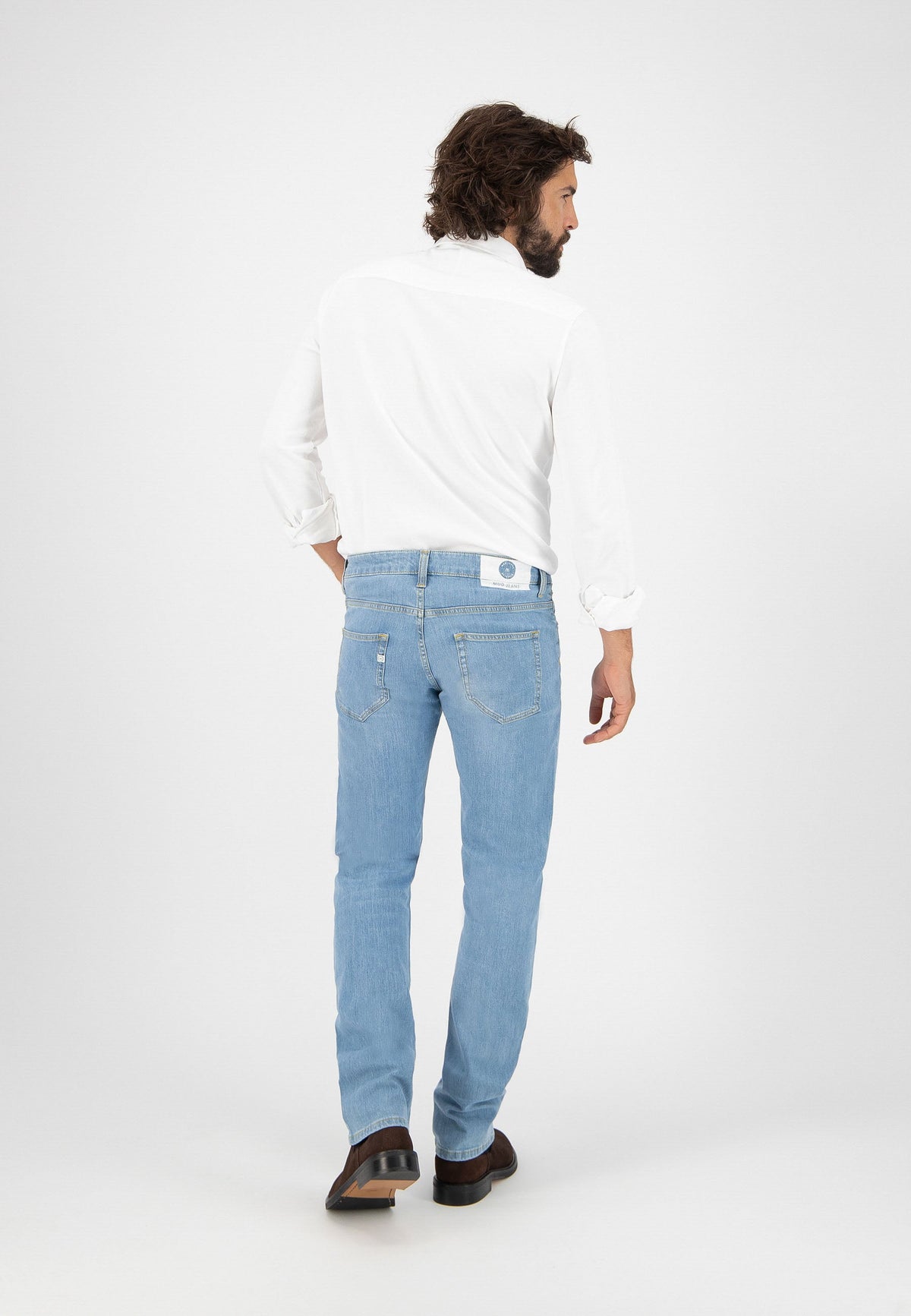 Sustainable MUD Jeans in dark blue denim with embroidered logo on pocket, highlighting ethical fashion choices.