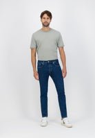 Sustainable MUD Jeans in light blue denim, paired with a gray sweater, emphasizing ethical and eco-friendly fashion.