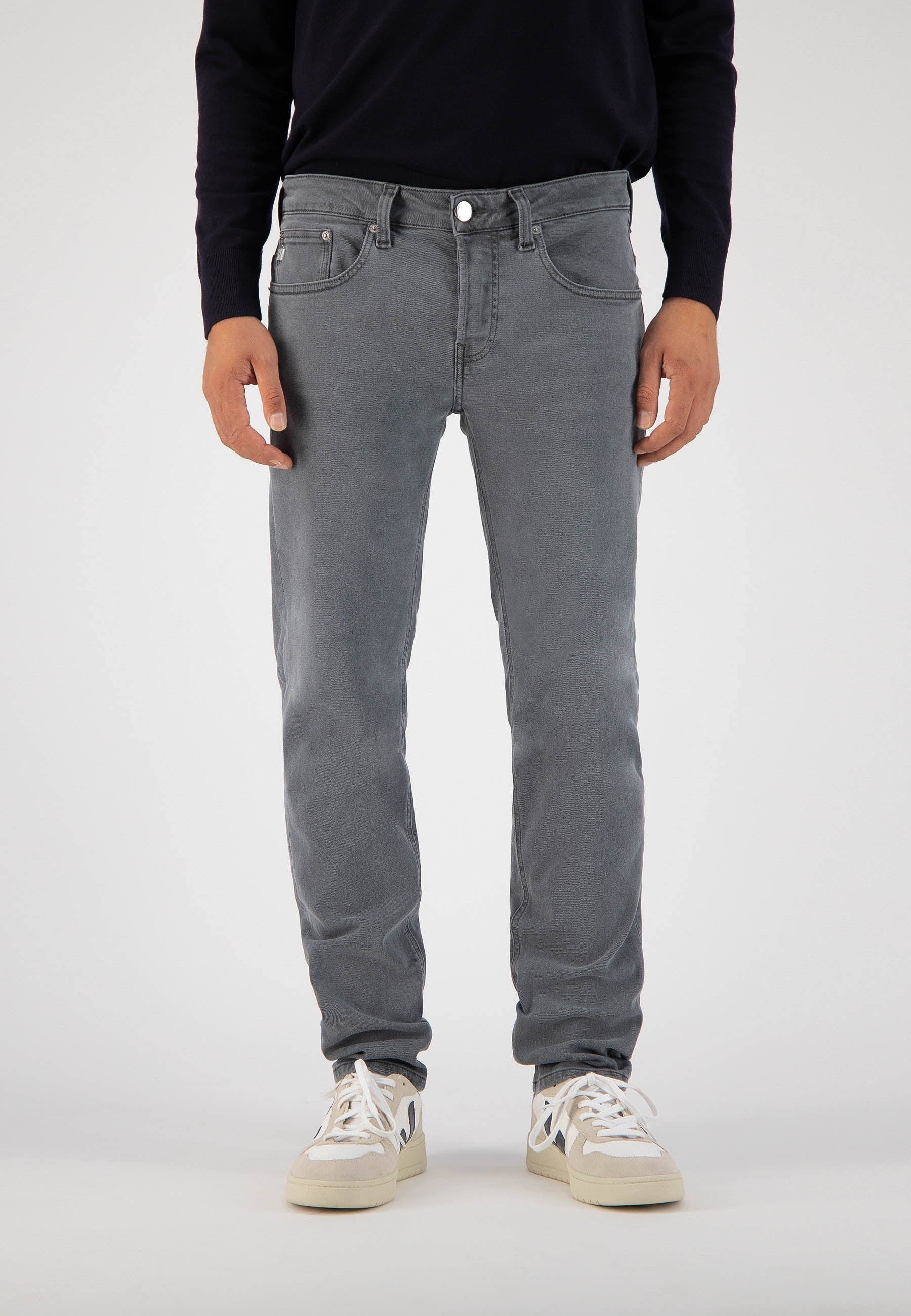 Sustainable MUD Jeans in dark blue denim paired with a blue denim shirt, embodying ethical fashion for a classic look.