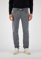 Sustainable MUD Jeans in dark blue denim paired with a blue denim shirt, embodying ethical fashion for a classic look.