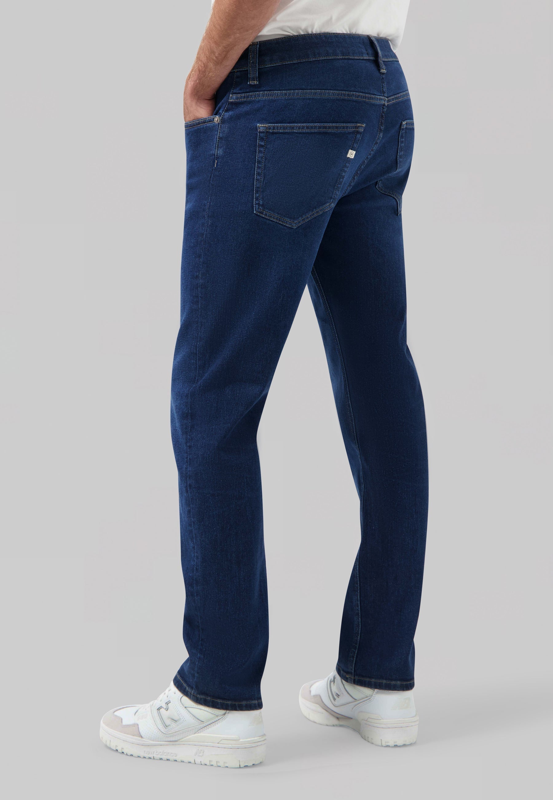 Sustainable MUD Jeans denim jacket in classic blue, worn with a matching blue cap, showcasing ethical fashion.