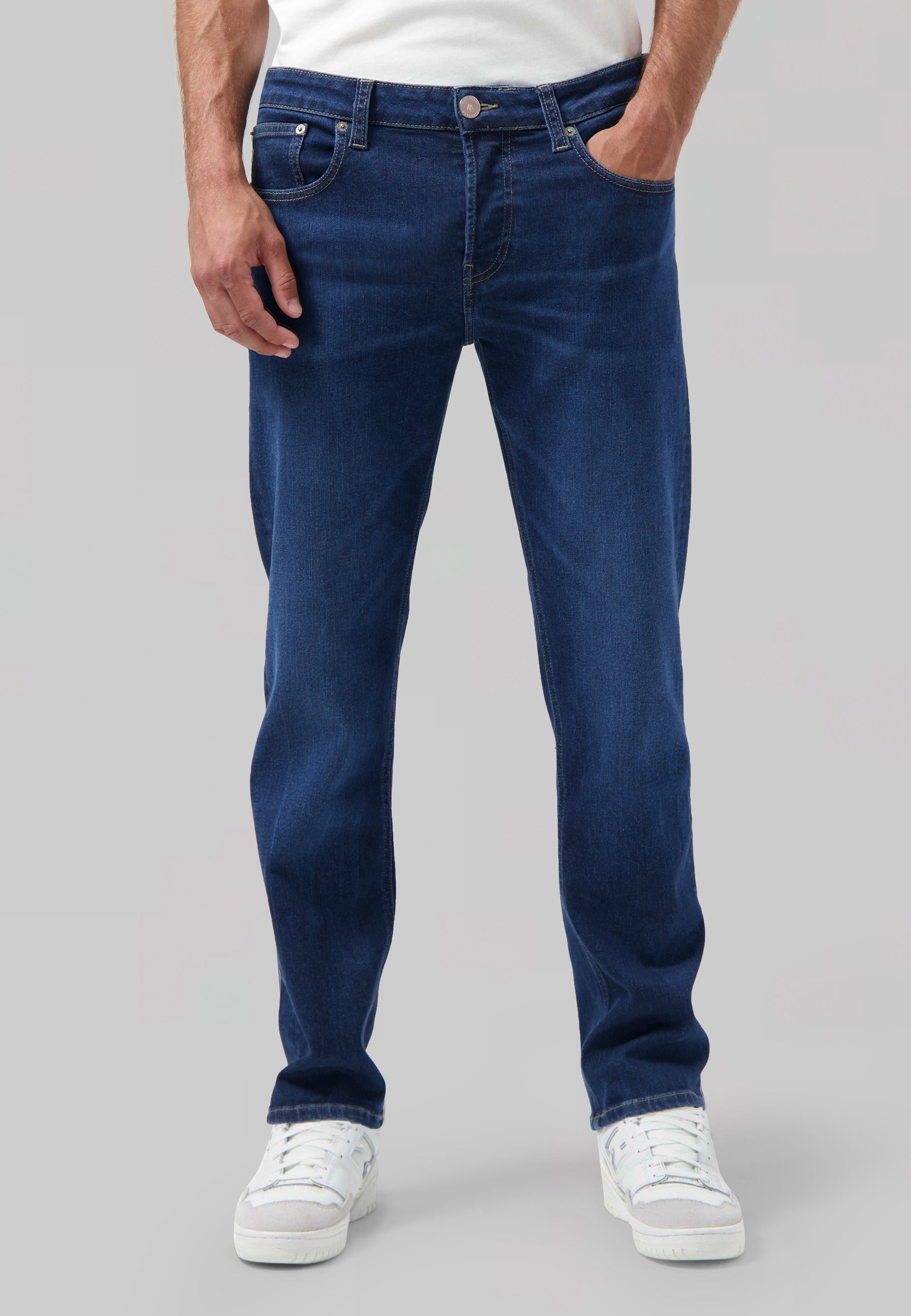 Sustainable MUD Jeans dark denim shirt paired with a blue cap, emphasizing ethical fashion and simple style.