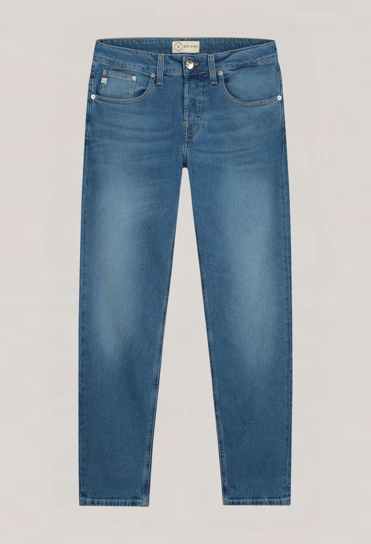Sustainable MUD Jeans cargo pants in dark blue denim, paired with a black top, highlighting ethical fashion.