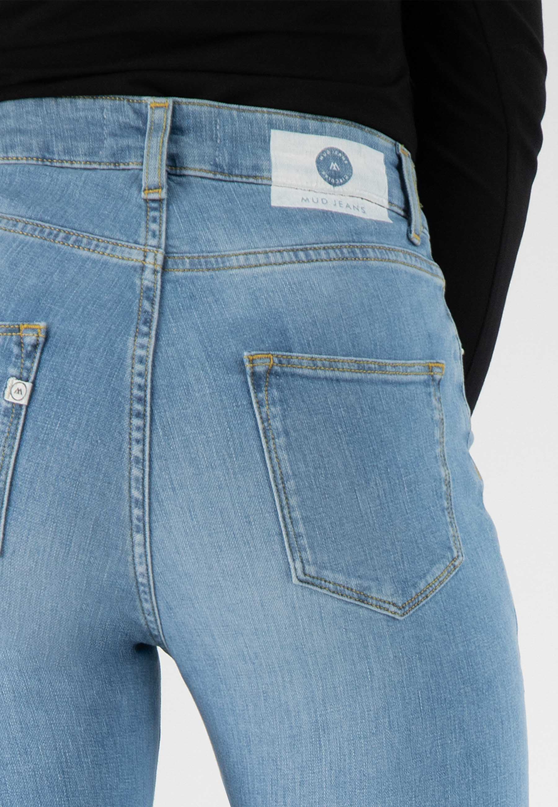 Light blue MUD Jeans made from sustainable materials, featuring a high-waist design with a visible back pocket.