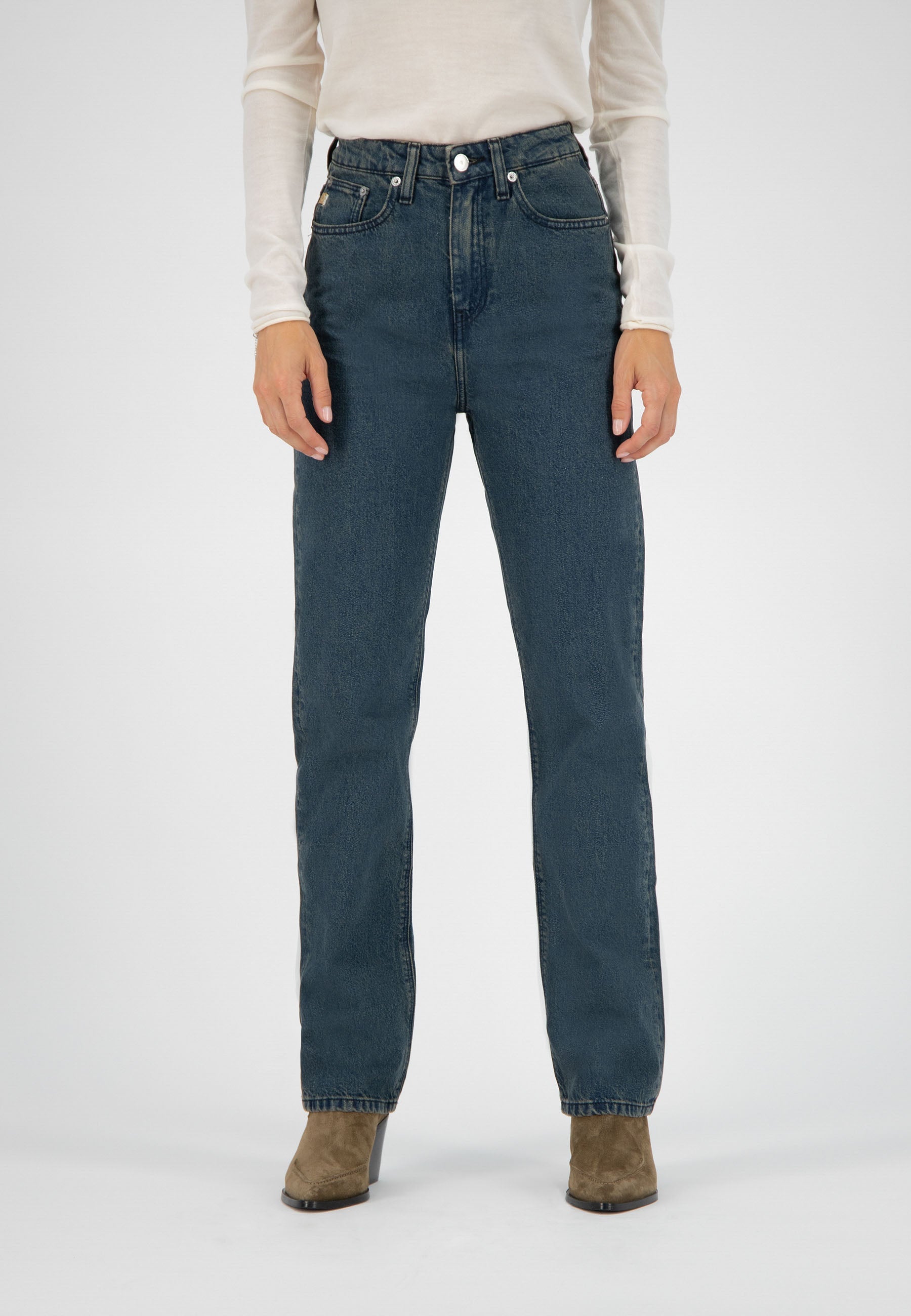 High-waisted straight leg blue jeans paired with a white long-sleeve top and brown suede ankle boots.