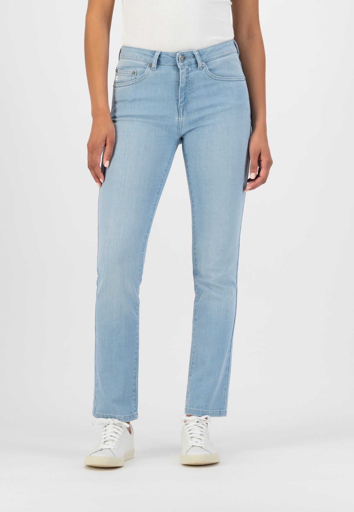 Light blue straight-leg jeans made from denim, modeled with a white sleeveless top and white sneakers, showcasing casual style.