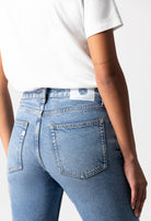 Light blue MUD Jeans in a classic fit, highlighting eco-friendly denim fabric, paired with a simple white T-shirt.