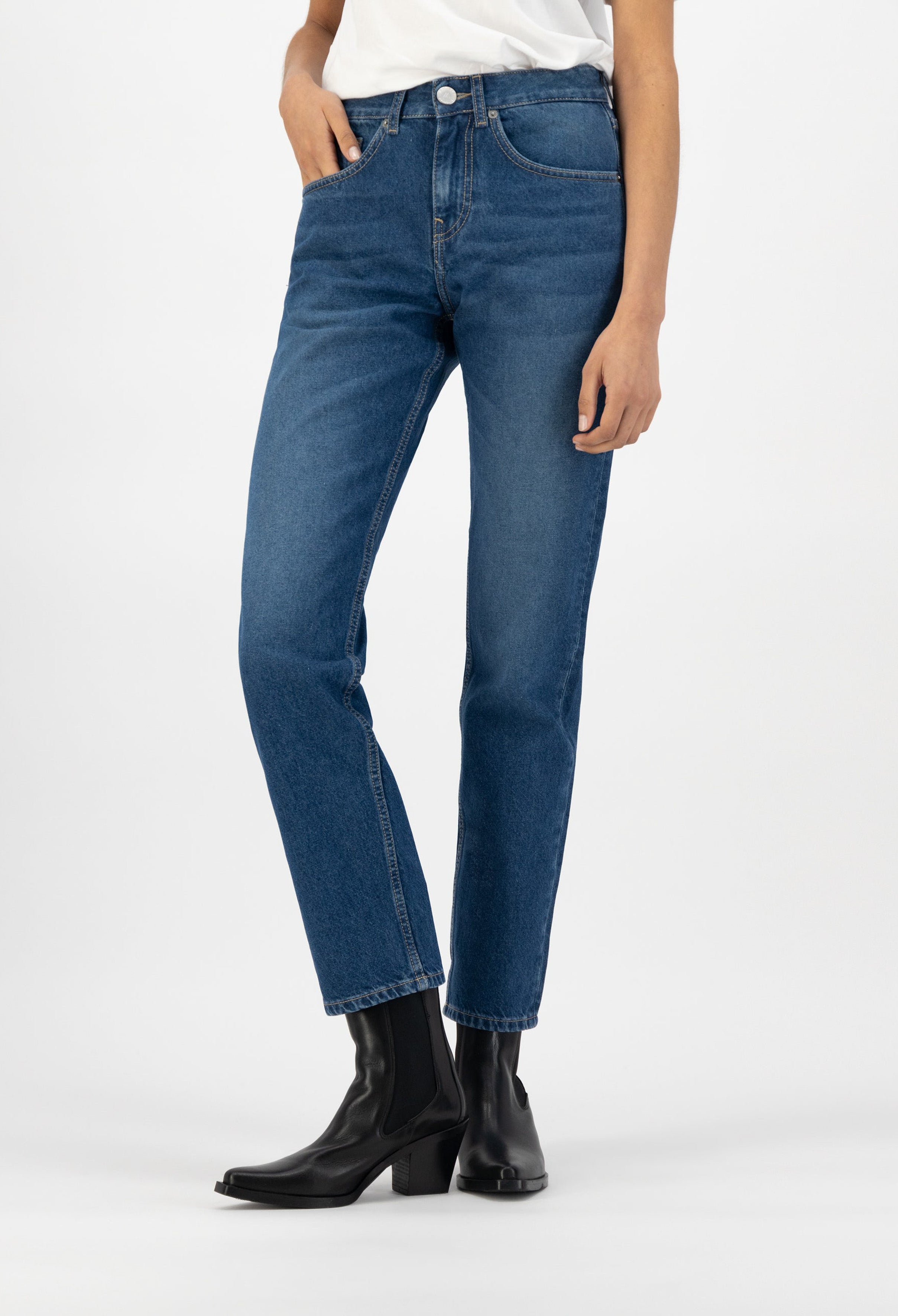 High-waisted blue jeans in a classic fit, paired with sleek black ankle boots, showcasing casual yet stylish fashion.