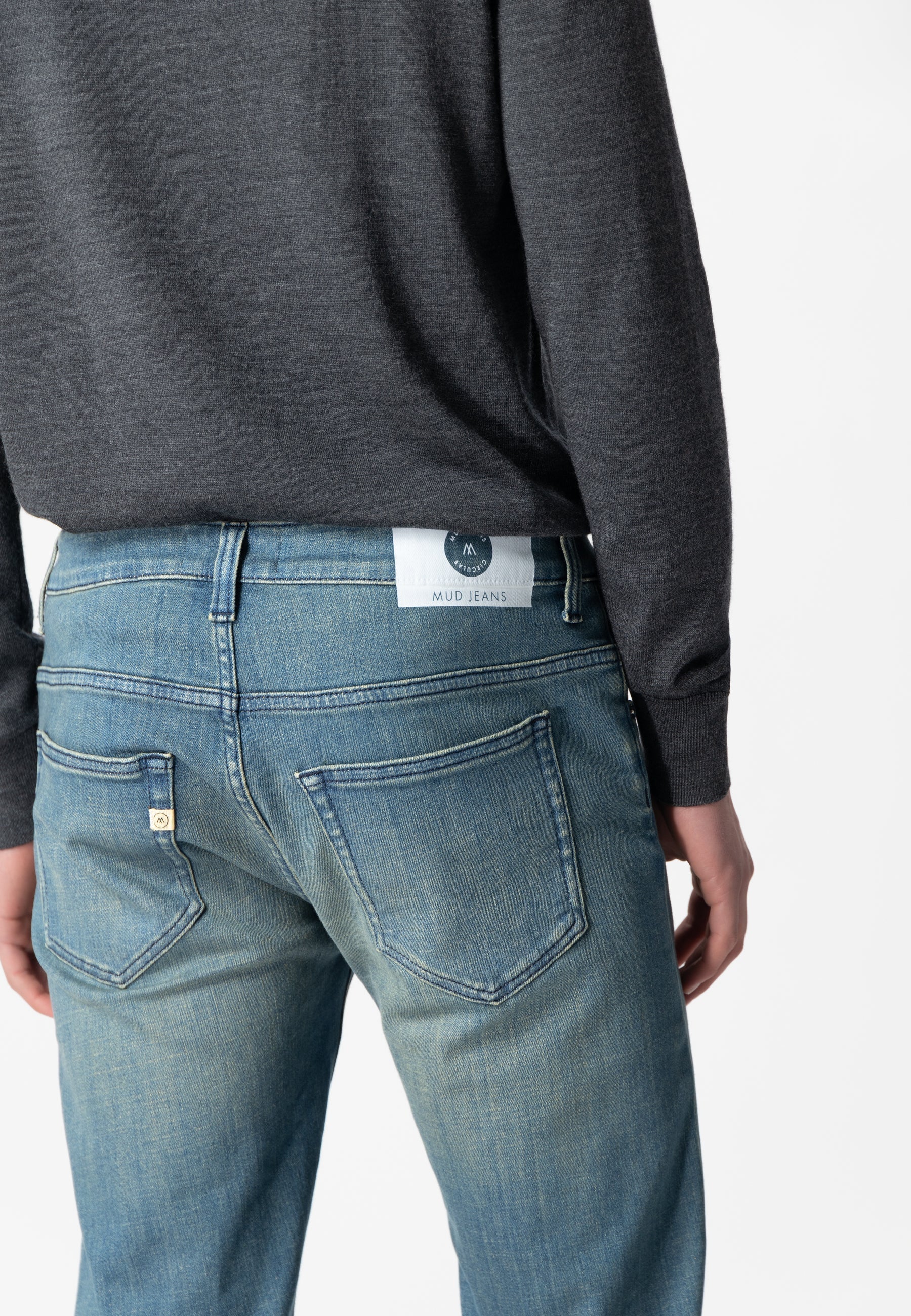 Sustainable Mud Jeans in deep blue denim, crafted from organic cotton for ethical fashion, featuring back pocket detail.