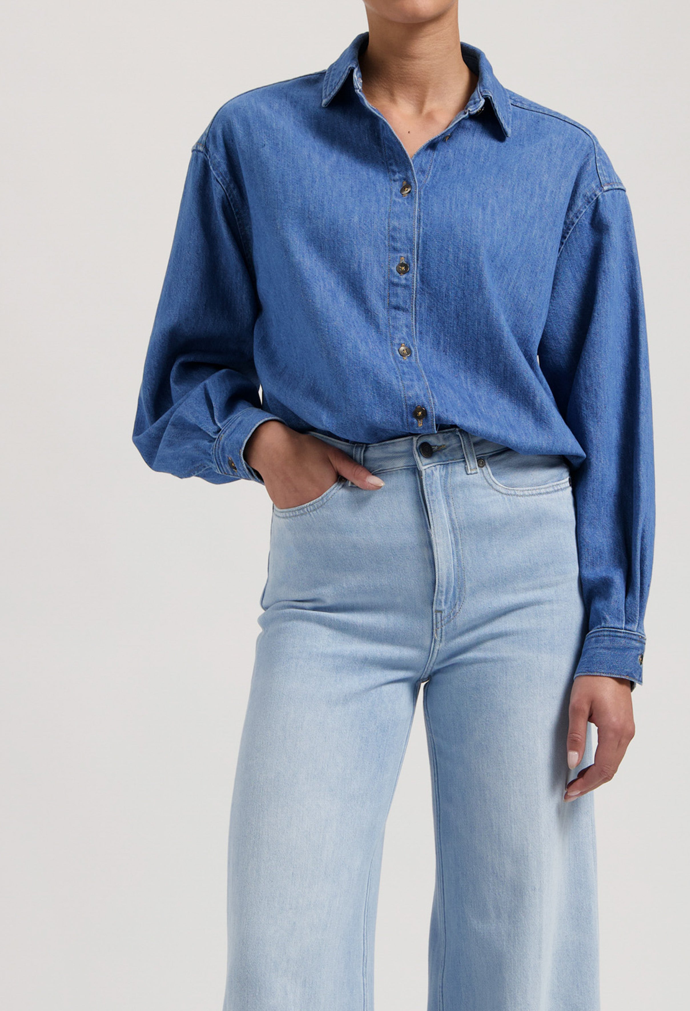 Light blue wide-leg jeans and blue denim button-up shirt ensemble showcasing casual style and comfort.